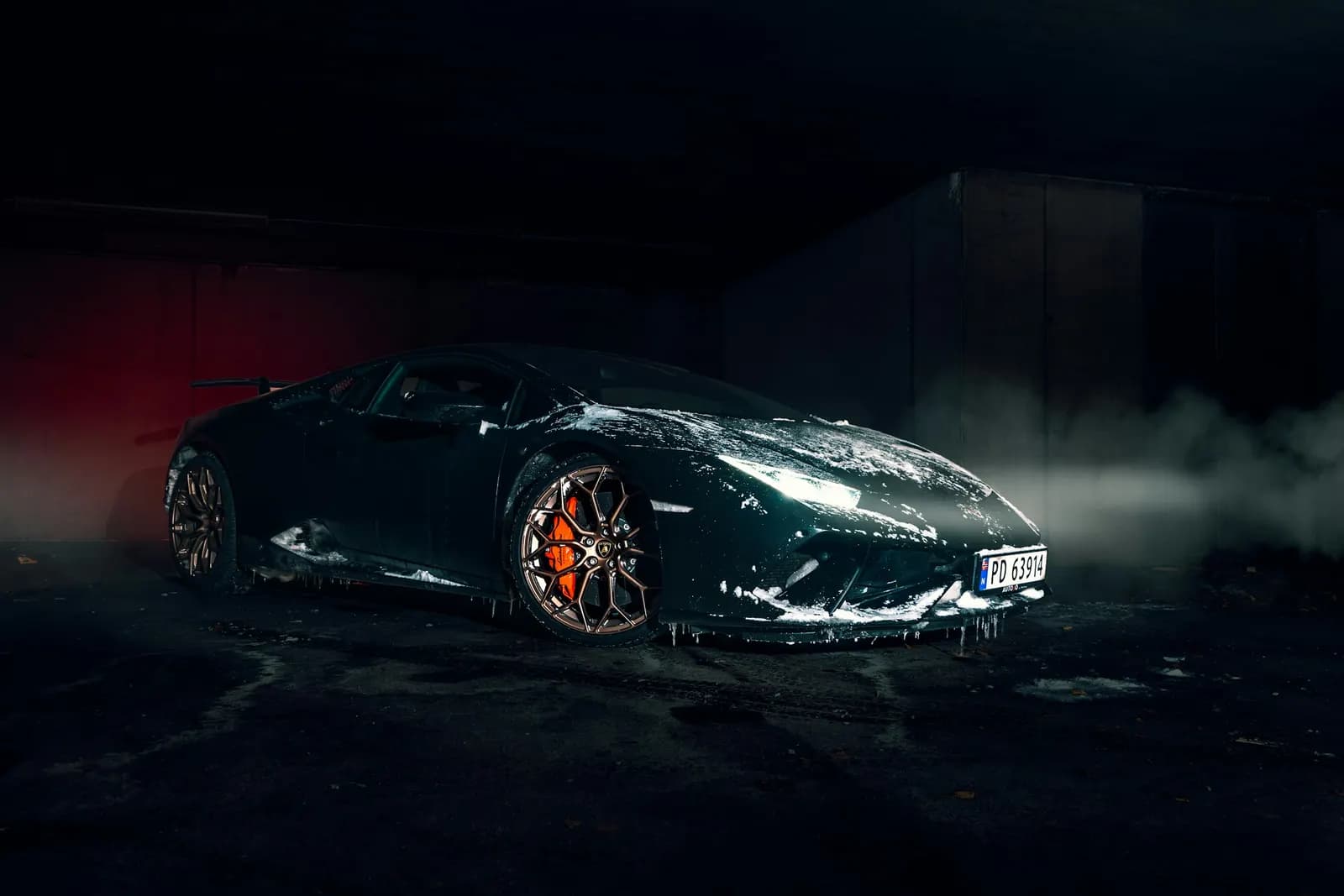 Grey Lamborghini Aventador in a dark smoky studio