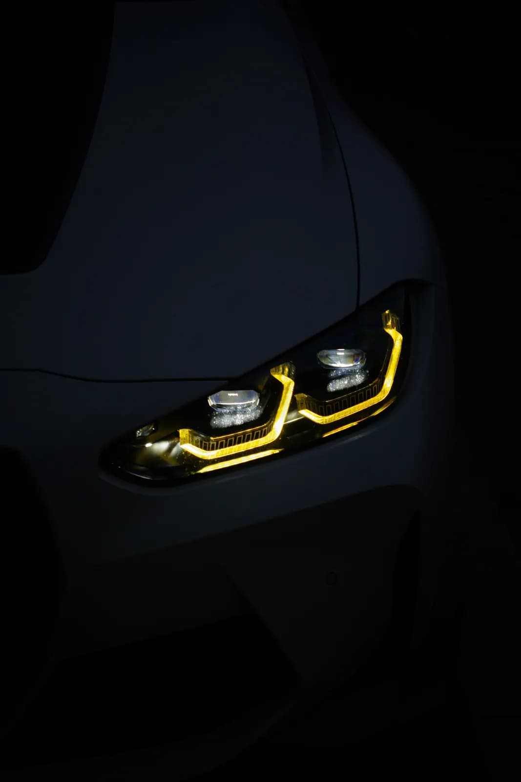Close-up of a car's LED headlight in the dark
