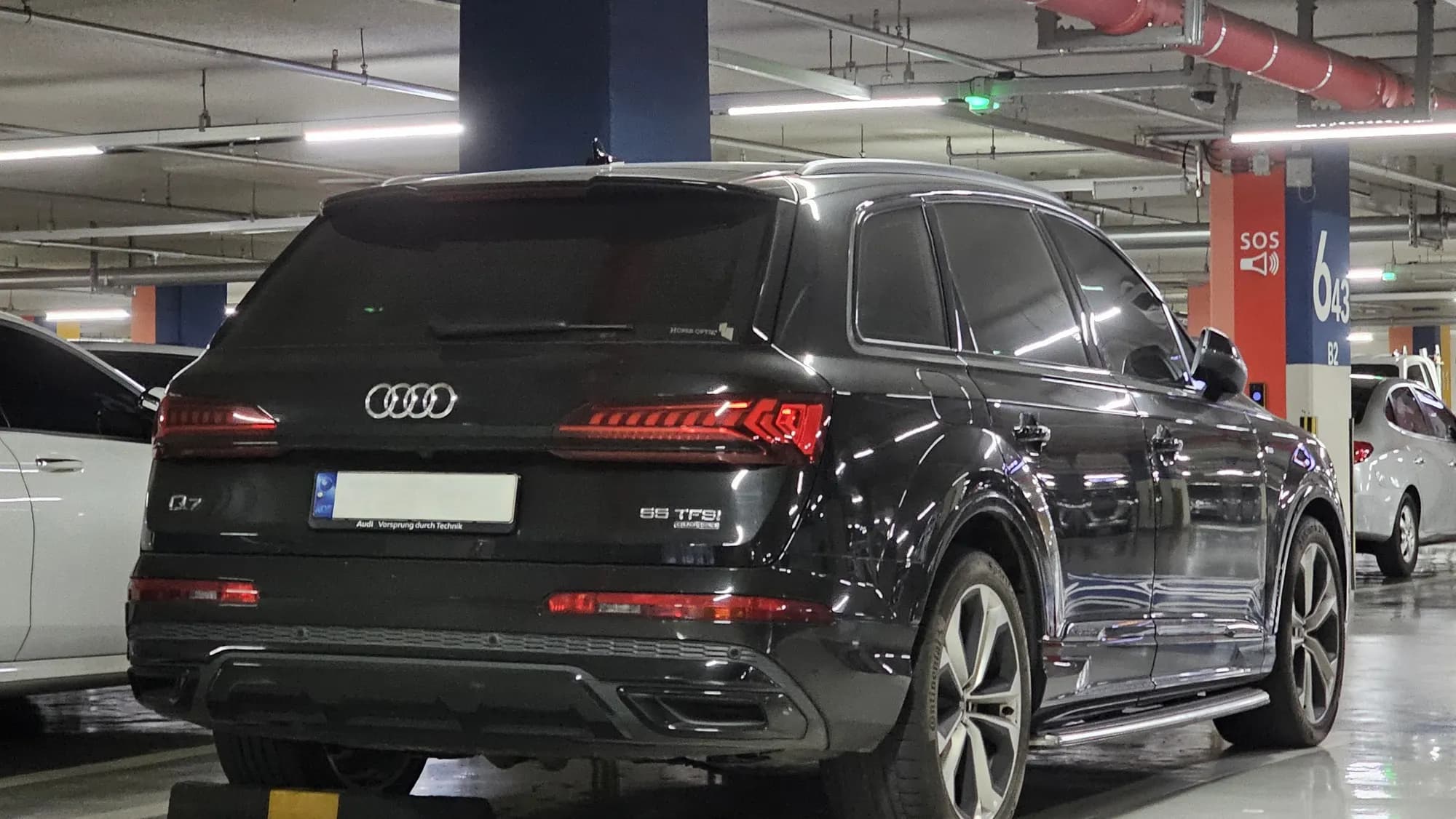 Black Audi Q7 S line, rear three-quarter view in an underground garage