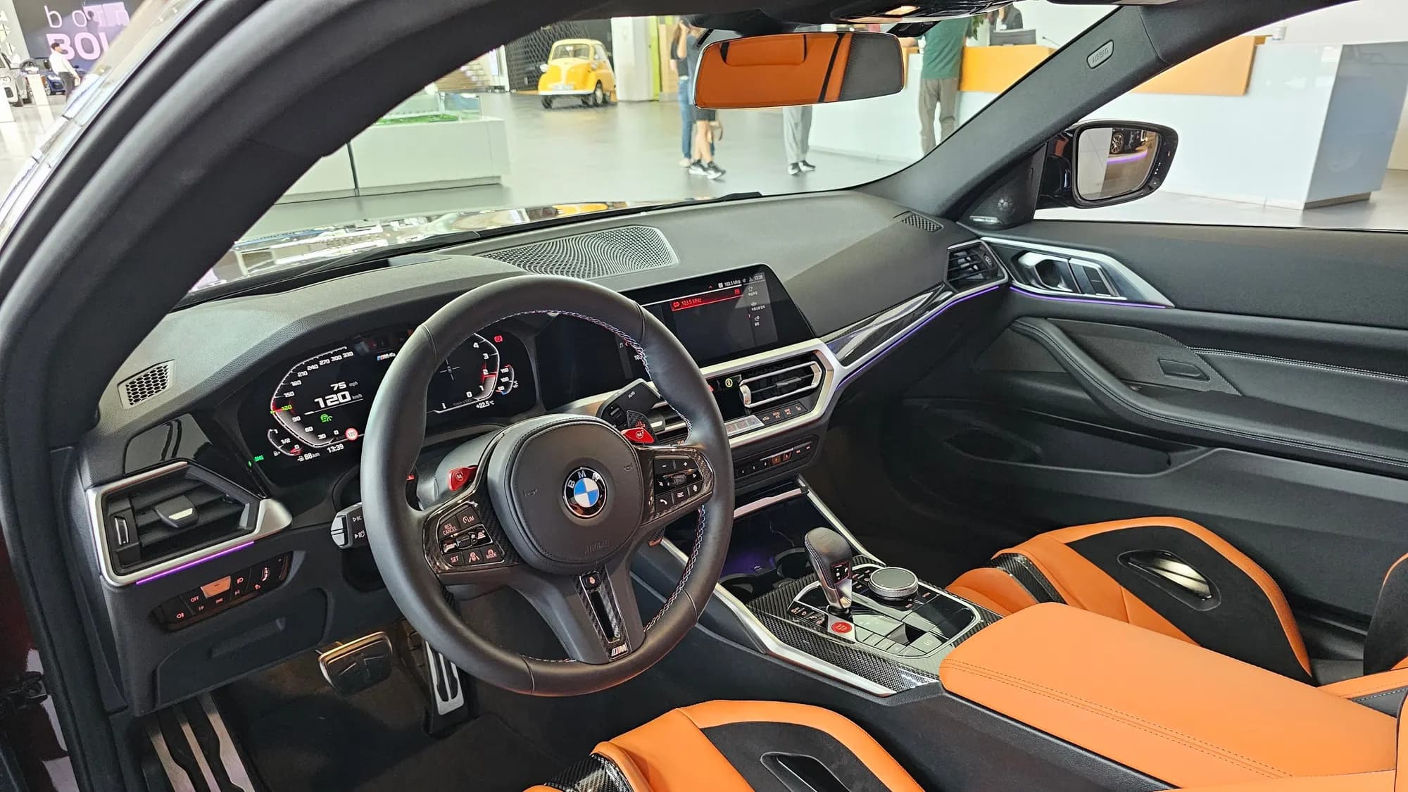 BMW M4 Competition interior with orange and black leather seats