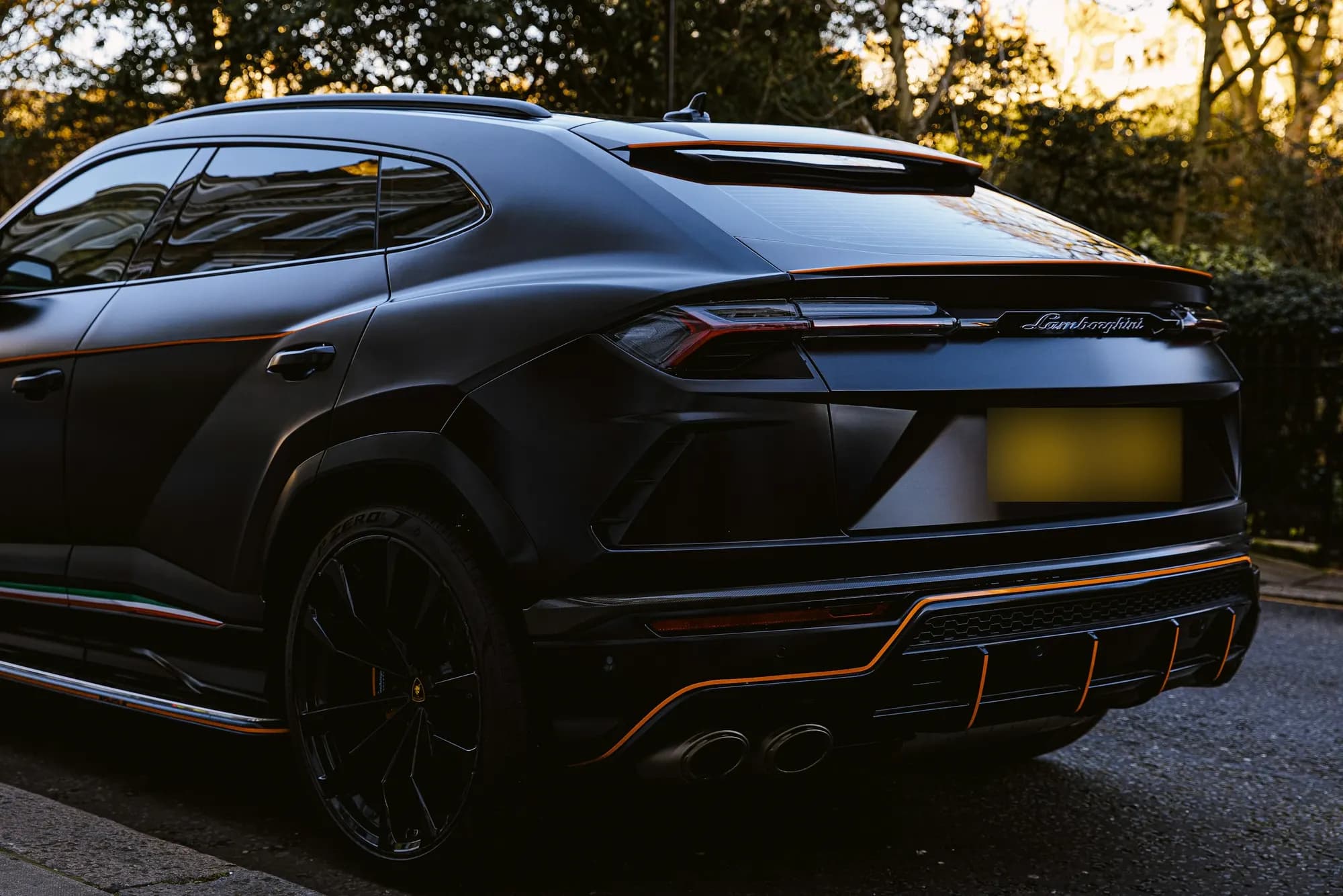 Matte black Lamborghini Urus, rear three-quarter view